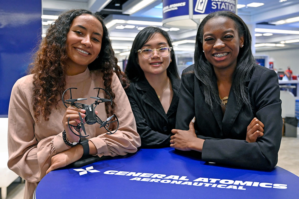 Students enjoy the General Atomics Aeronautical exhibit at the 2023 AIAA SciTech Forum