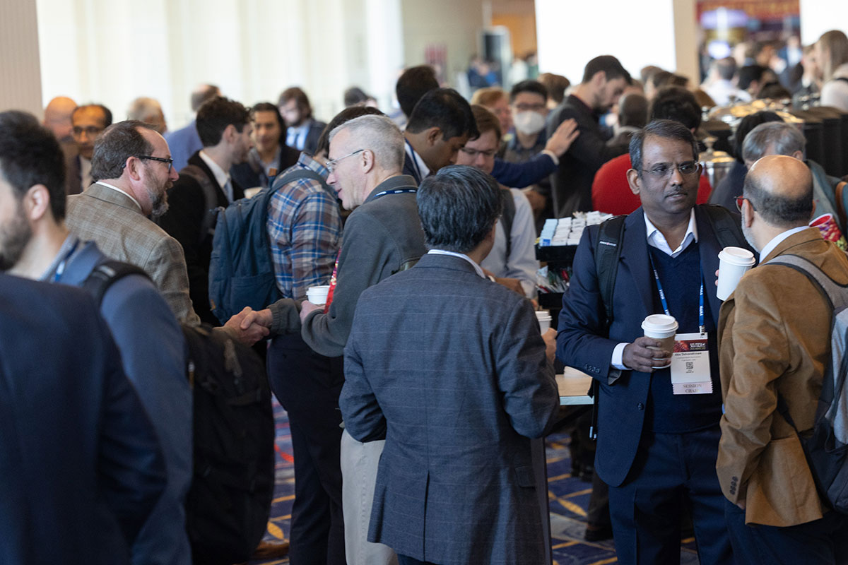2023 forum attendees network during a coffee break